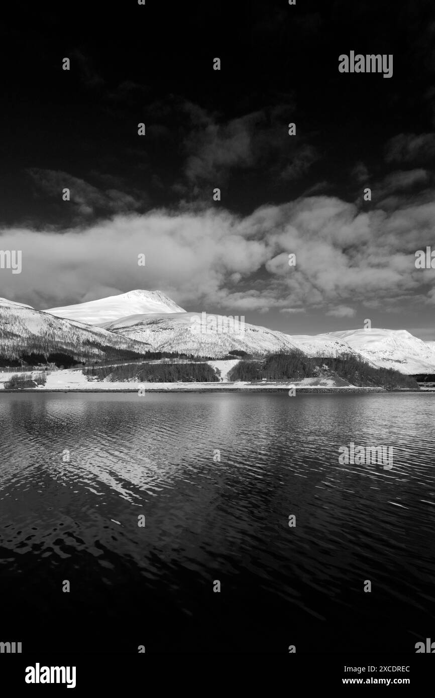 View from a boat of the mountains along Ramfjord, a scenic Fjord south of Tromso city, Northern Norway Stock Photo