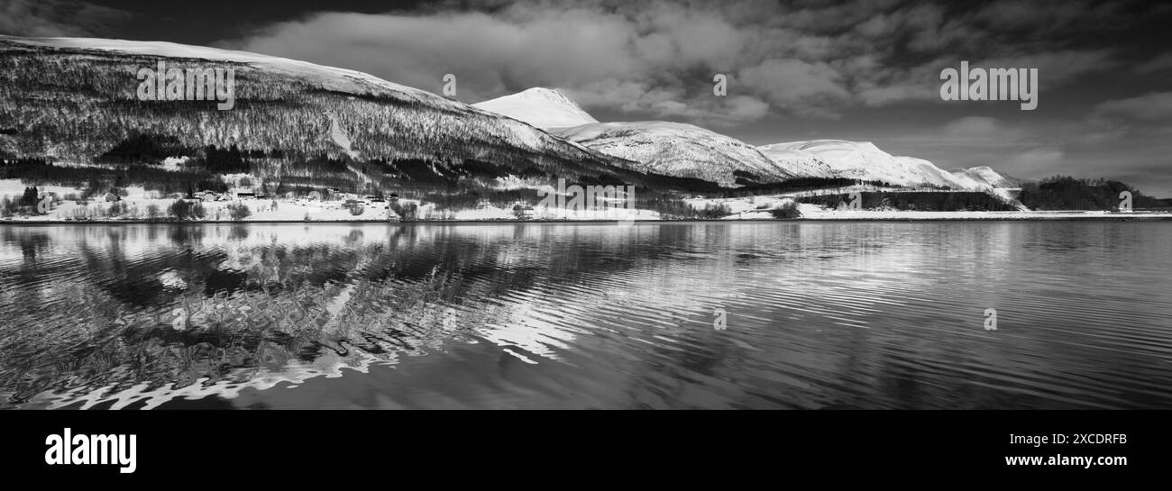 View from a boat of the mountains along Ramfjord, a scenic Fjord south of Tromso city, Northern Norway Stock Photo
