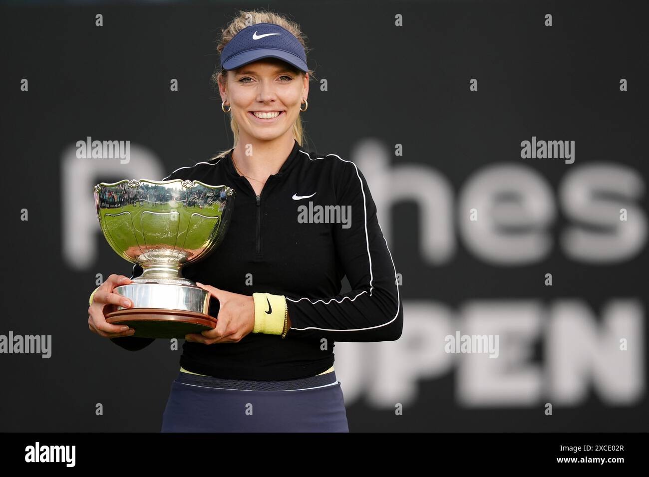 Katie Boulter celebrates with the trophy after winning her women's