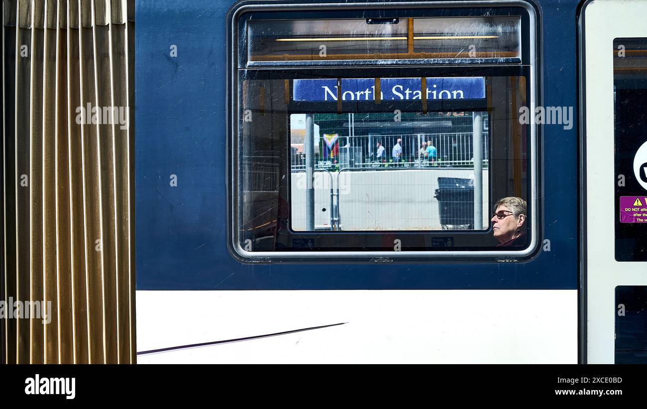 Blackpool trams return to the town centre after over 60 years.The new North Railway Station tram route opened on the 16th June 2024 diverting trams off the promenade and up to the newly opened Holiday Inn interchange. Women passenger looks out of the window at the new North railway station stop Stock Photo