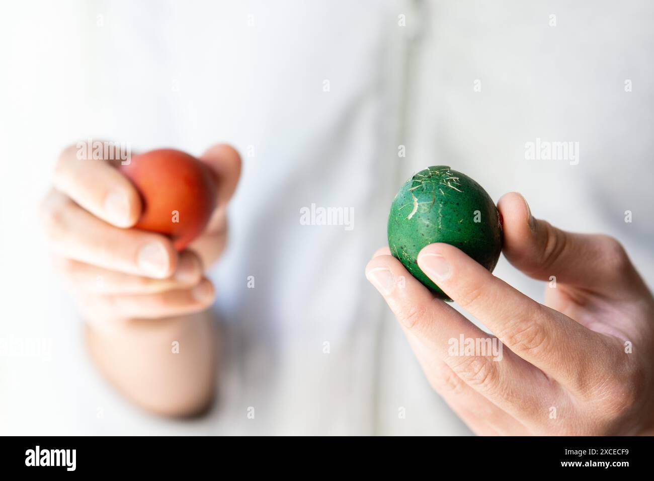 close up of hands holding crashed broken easter eggs Stock Photo