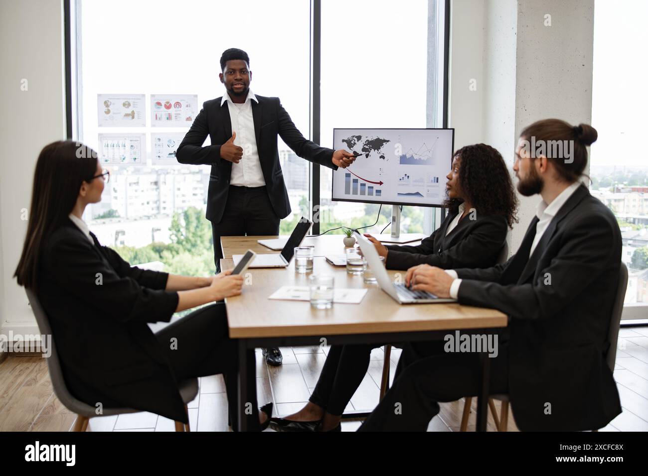 Business presentation with team discussing charts and graphs Stock ...