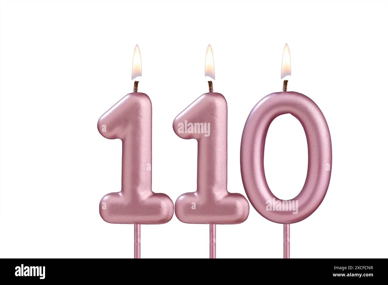 Lit birthday candle - Candle number 110 on white background Stock Photo