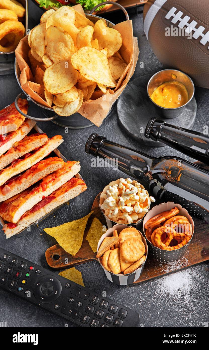 Selection of party food for watching football championship on a dark ...