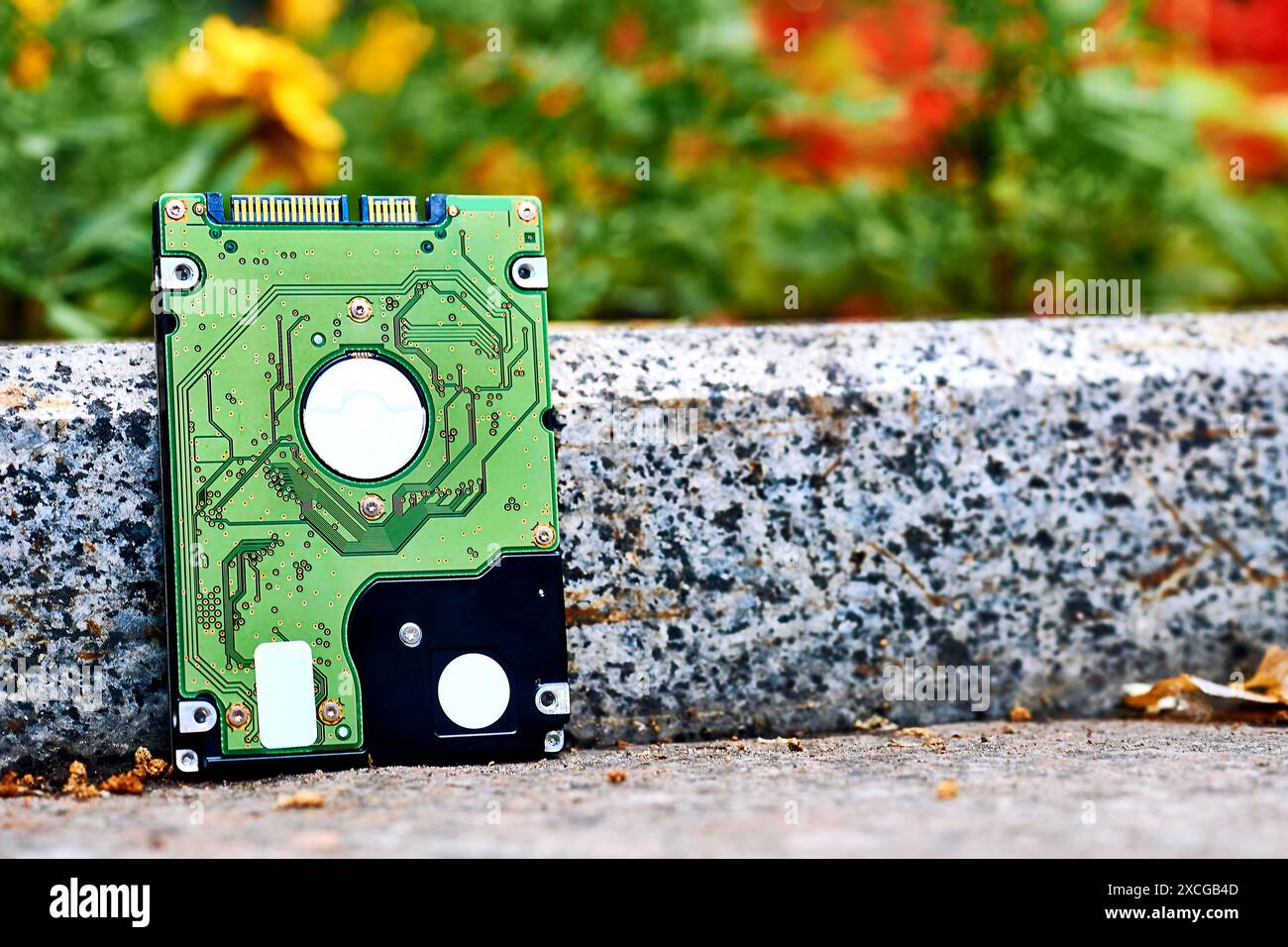 Green Internal hard drive for storing information on sidewalk Stock Photo