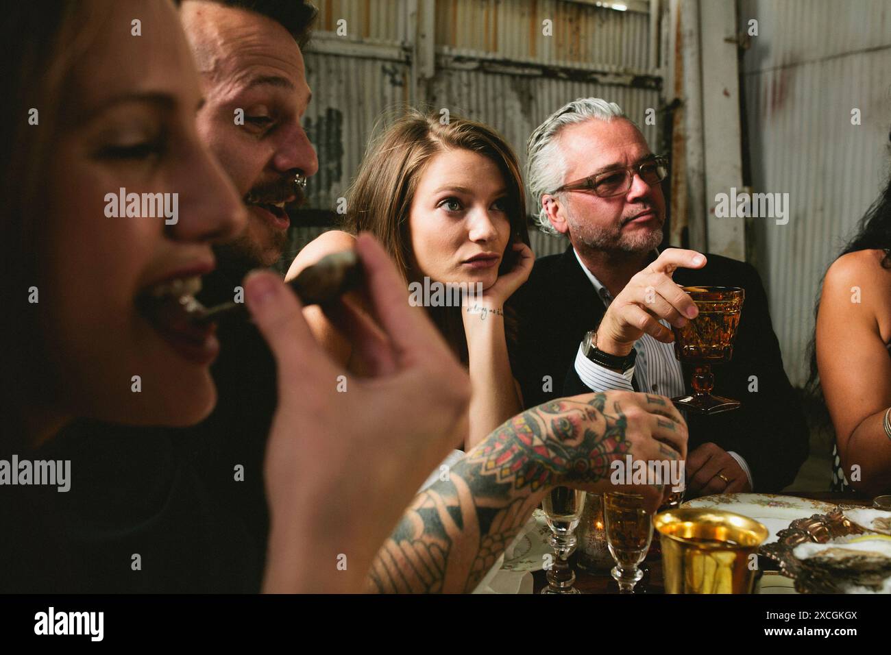 Friends eating and drinking during oyster party Stock Photo - Alamy