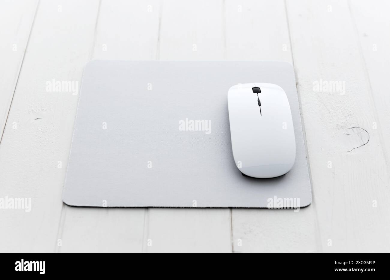 White wireless mouse on a mouse pad Stock Photo