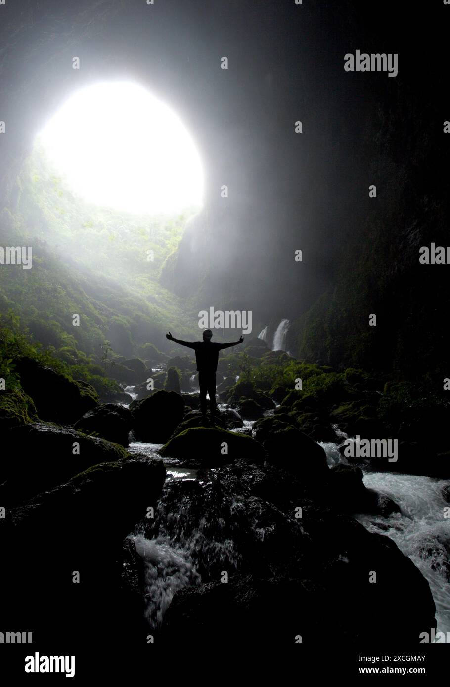 A cave explorer shows his delitghts on discovering a huge river cave in New Britain Stock Photo