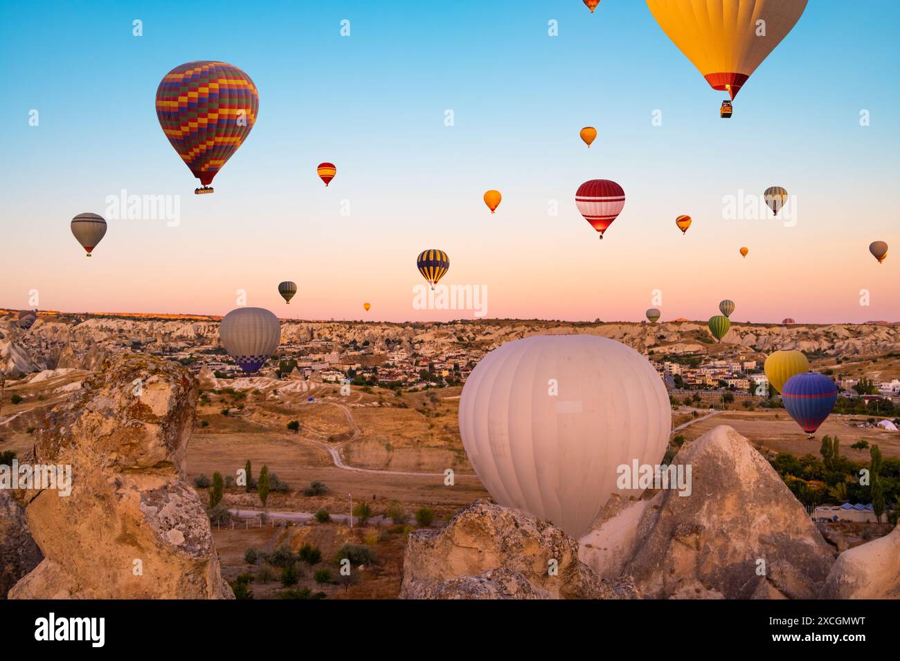 Colorful hot air balloons taking part in festival in sunset sky Stock ...