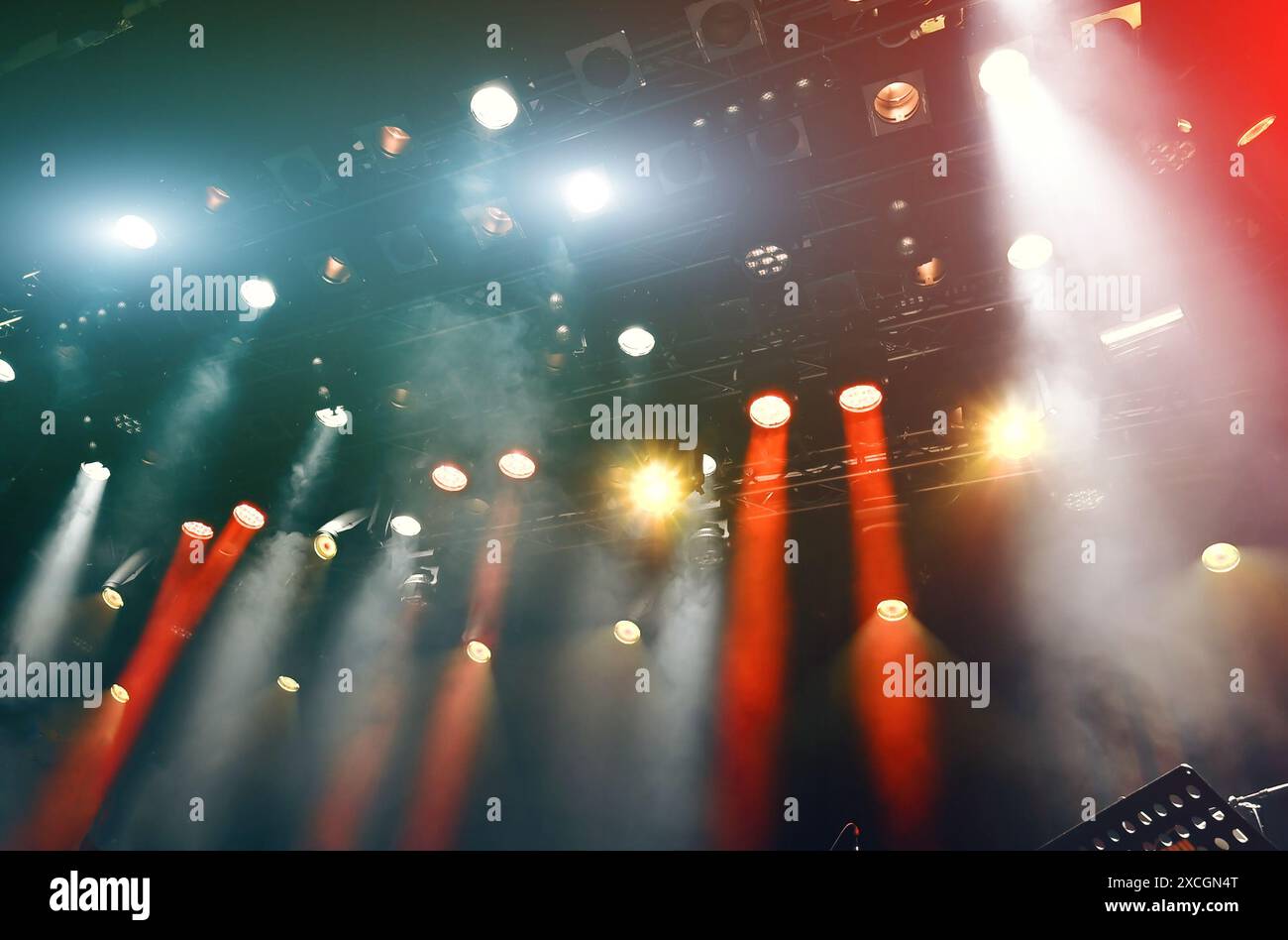 ceiling spotlights working during the show, musical concert light with spotlights and mist Stock Photo