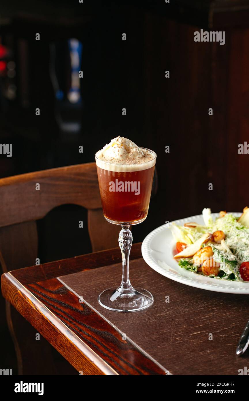 alcoholic cocktail with ice cream in the interior of the bar Stock Photo