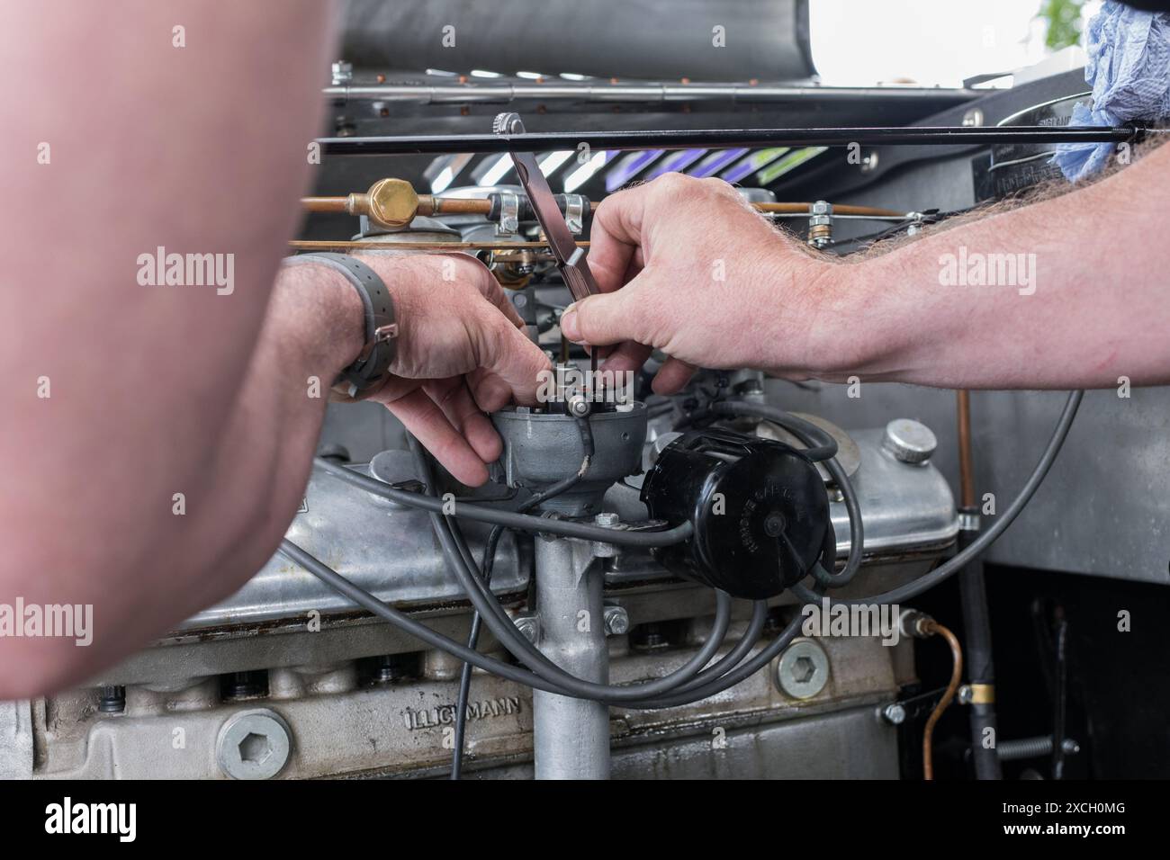racing car mechanic working on and adjusting the electrical points in
