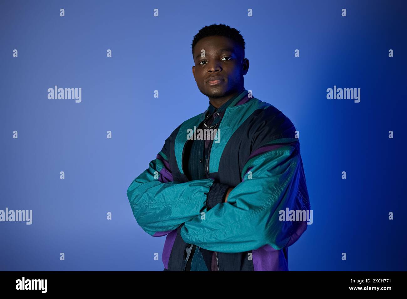 Handsome African American man in blue jacket strikes a pose against