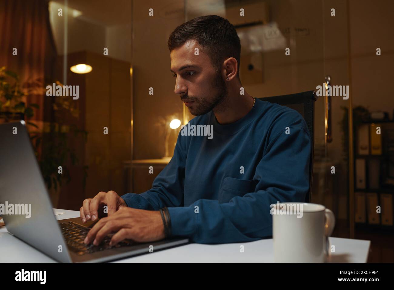 Portrait of serious coding developer working on laptop in office Stock Photo