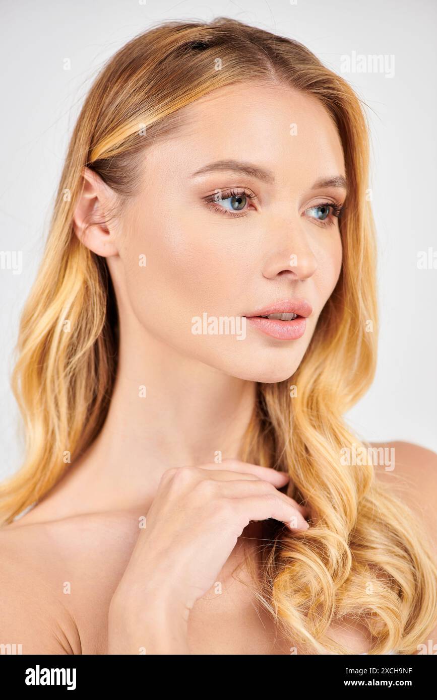 Woman with long blonde hair striking a pose. Stock Photo