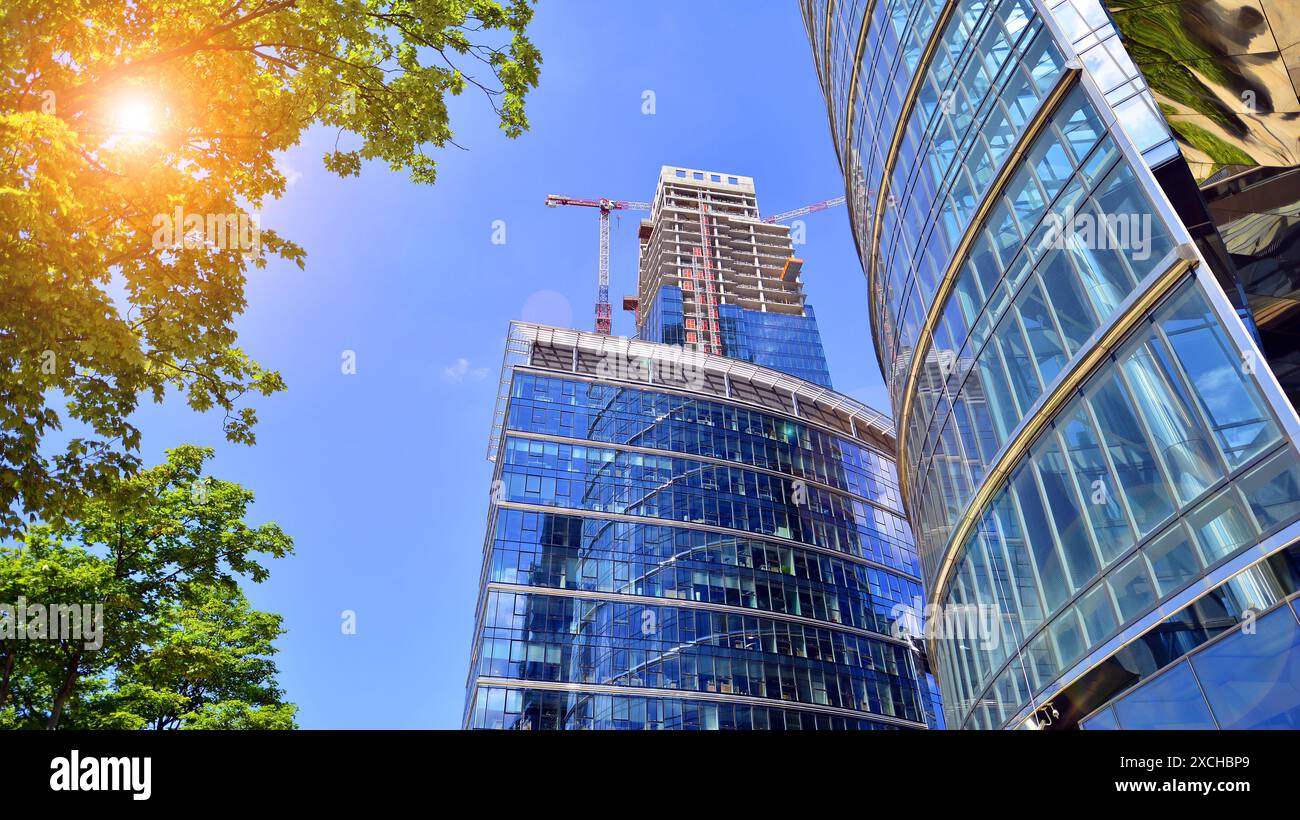 High rise building under construction. Installation of glass facade ...