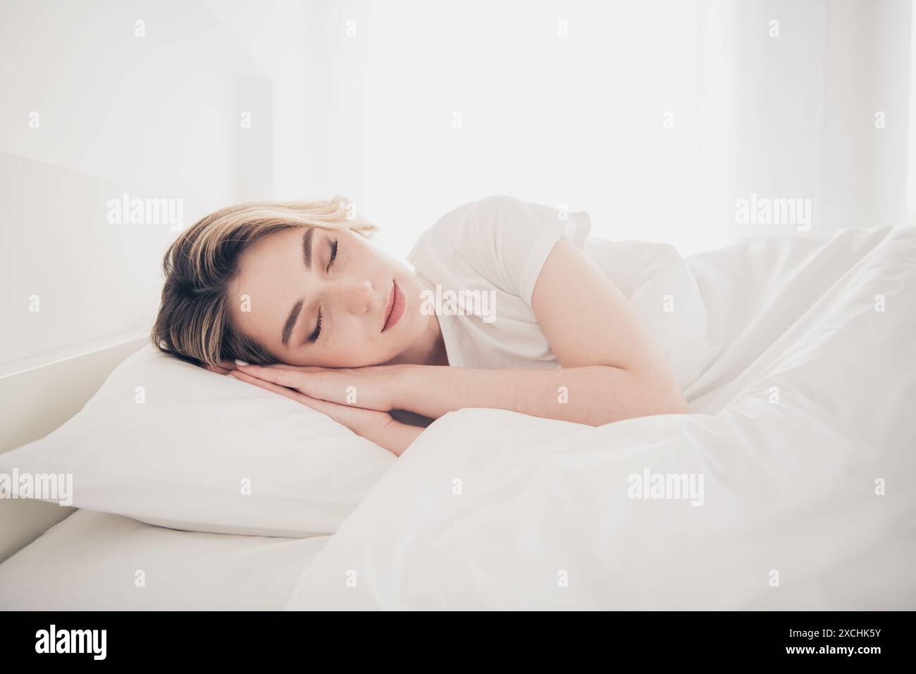 Photo of girl lying bed sleeping in white bedroom interior Stock Photo ...