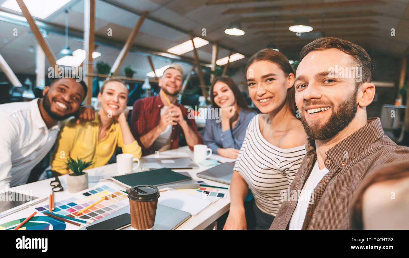 Happy designers making selfie at workplace, working on project Stock Photo
