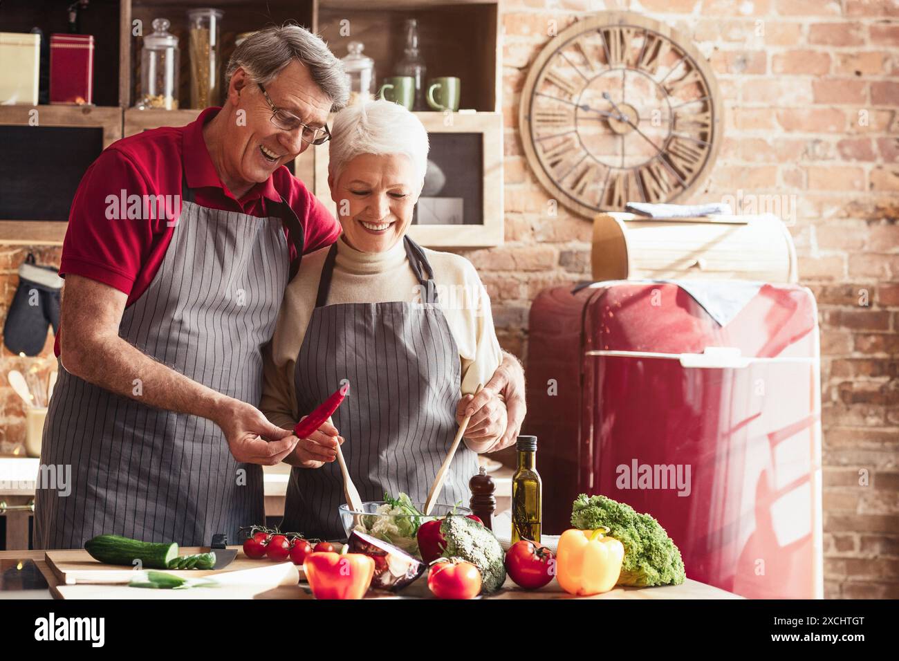 Senior Couple Having Fun While Cooking in the Kitchen Stock Photo
