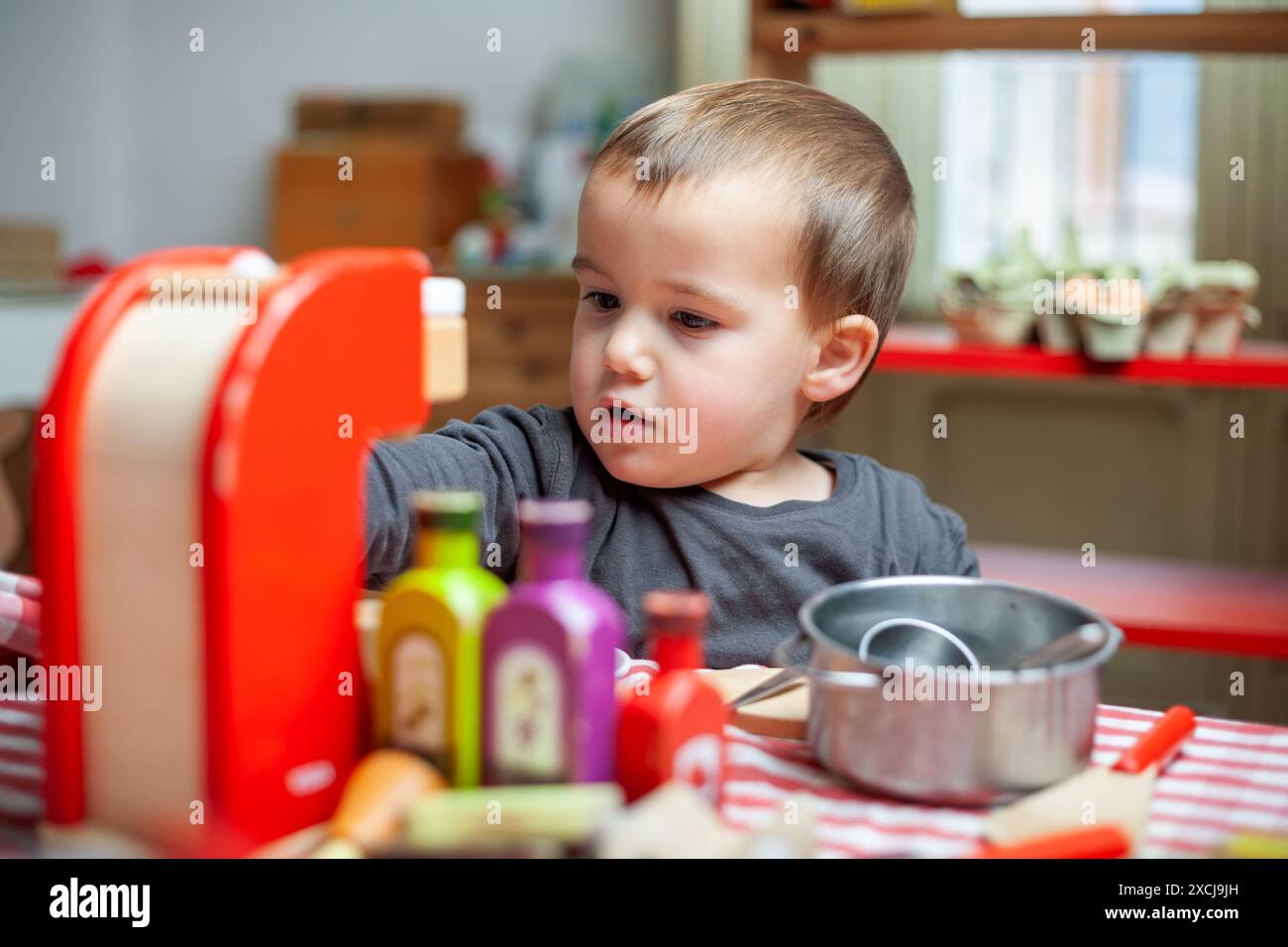 Little boy plays at making coffee in playroom. Imaginative play ...