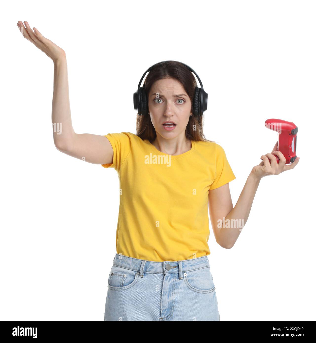 Confused woman in headphones with game controller on white background ...