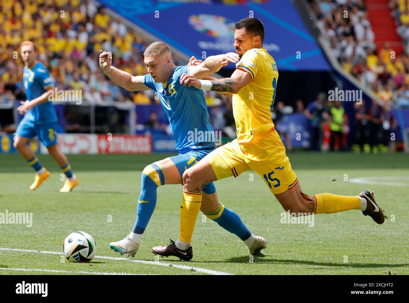 Munich, Germany. 17th June, 2024. Andrei Burca (R) of Romania competes against Artem Dovbyk of Ukraine during the UEFA Euro 2024 Group E match between Romania and Ukraine in Munich, Germany, on June 17, 2024. Credit: Philippe Ruiz/Xinhua/Alamy Live News Stock Photo