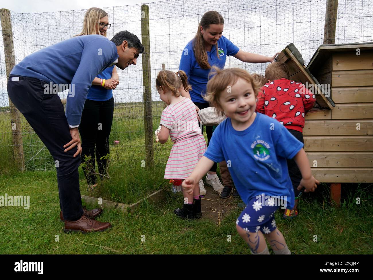 Prime Minister Rishi Sunak helps the children collect eggs during a