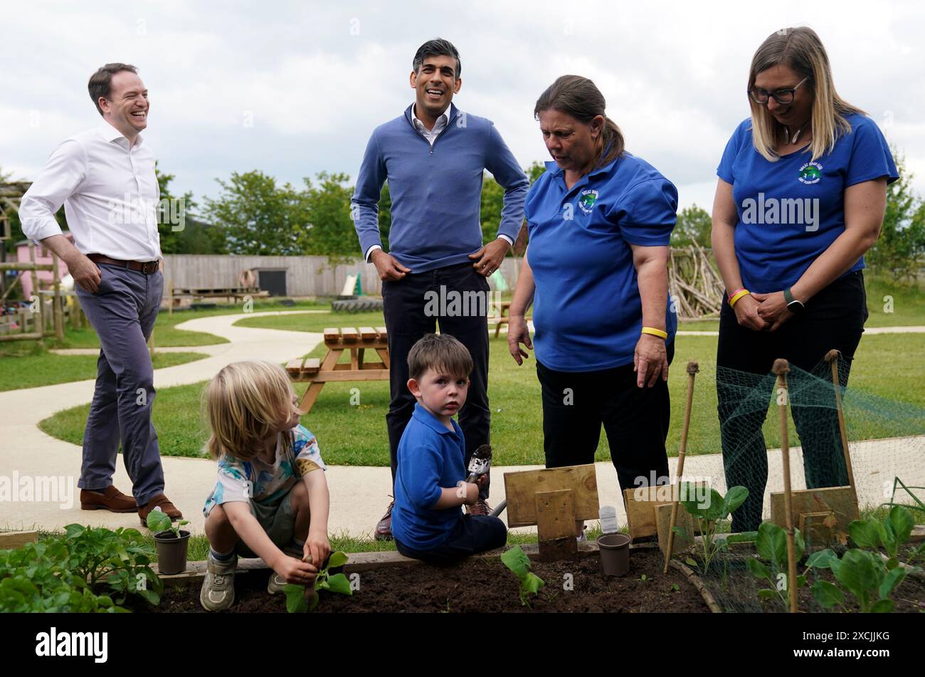 Prime Minister Rishi Sunak helps children with gardening during a visit