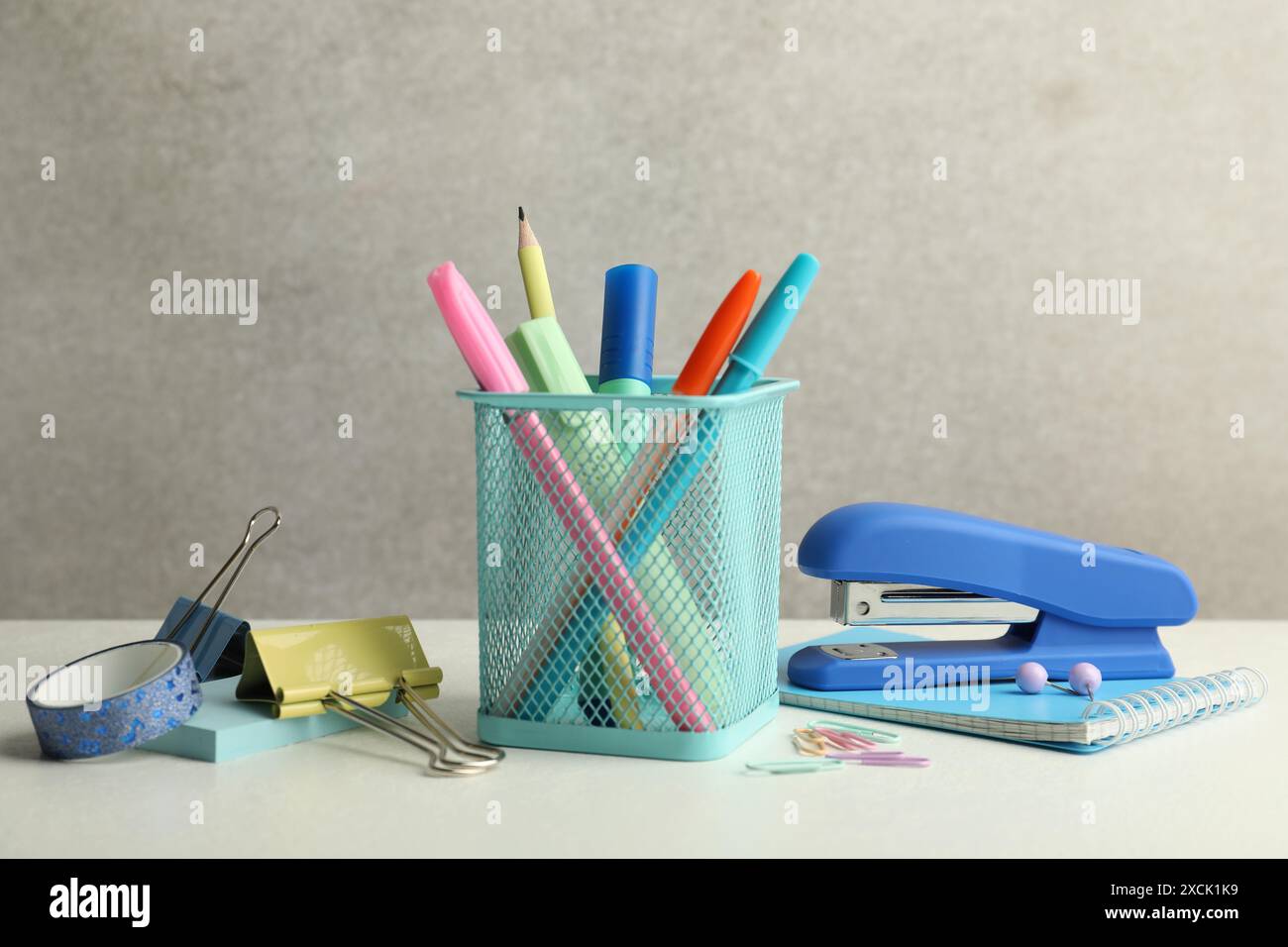 Stapler, holder and other different stationery on white table Stock Photo