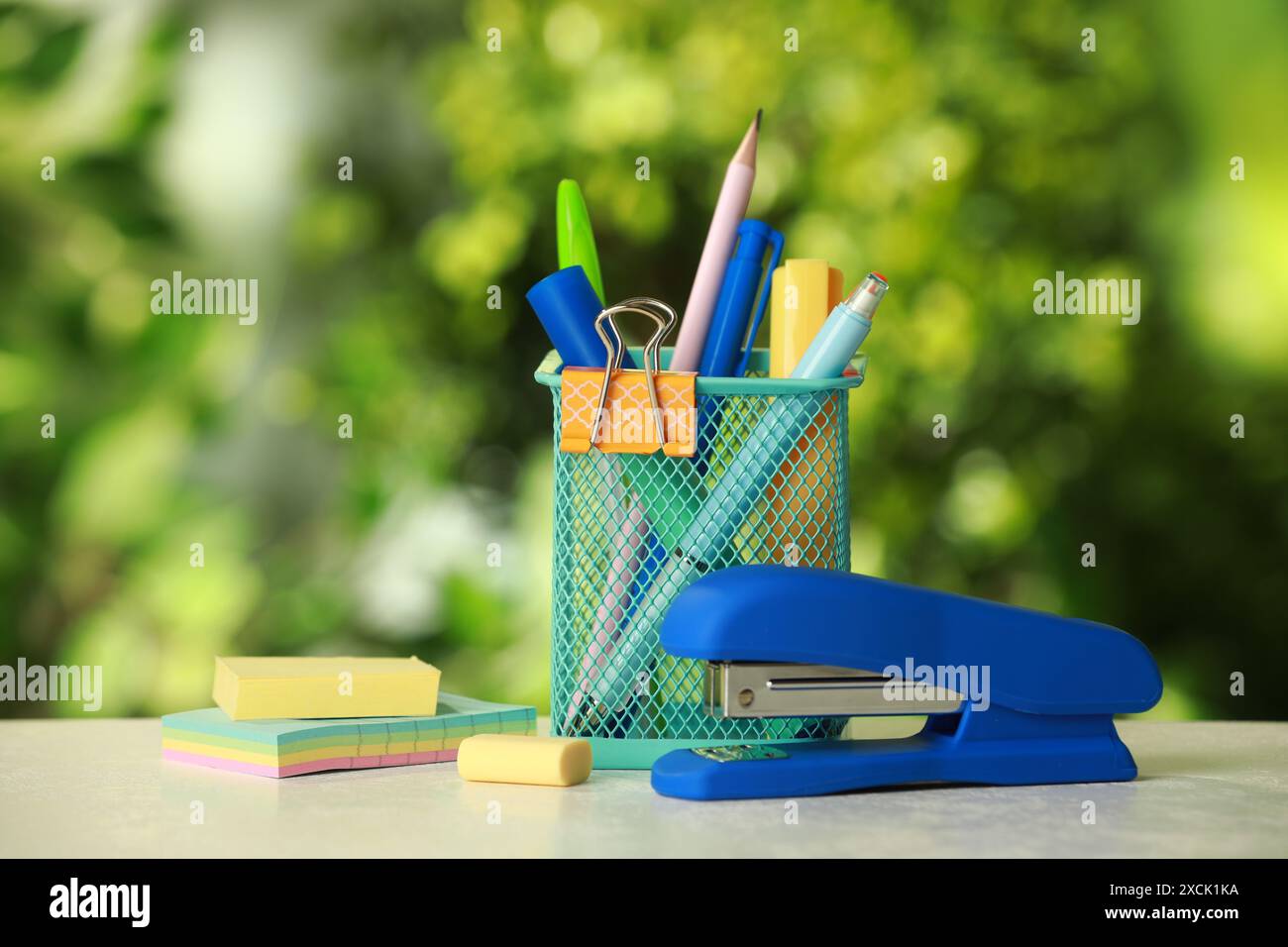 Stapler, holder and other different stationery on white table Stock Photo