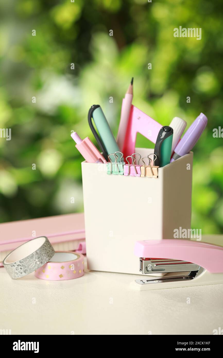 Stapler, holder and other different stationery on white table Stock Photo