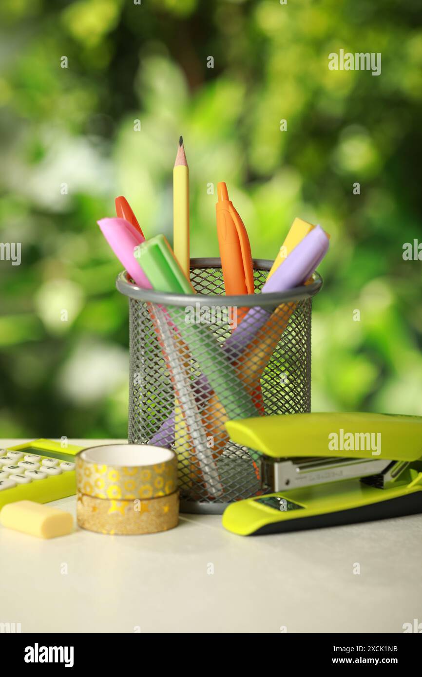 Stapler, holder and other different stationery on white table Stock Photo