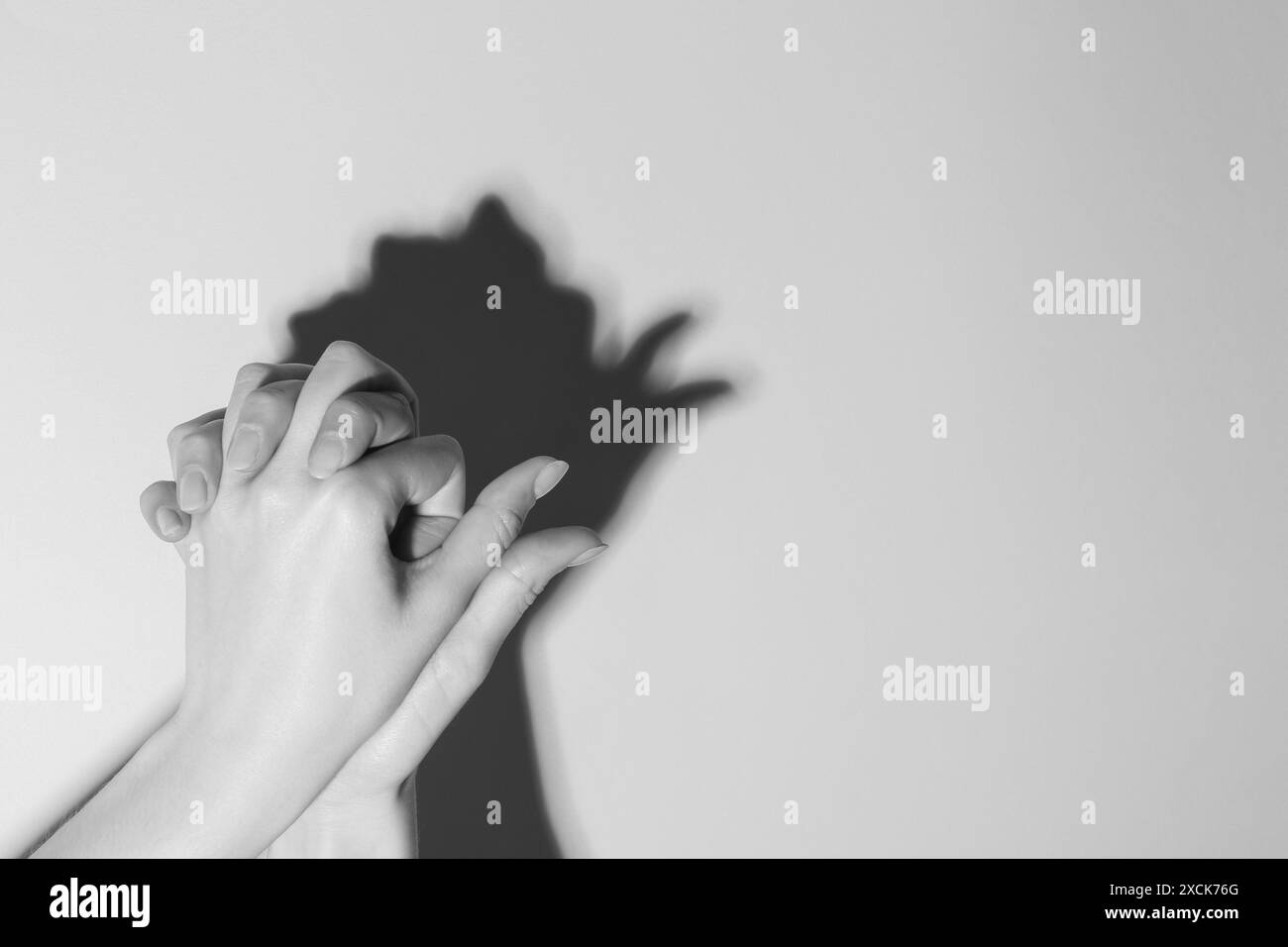 Woman making hand gesture like bird on light background, closeup with