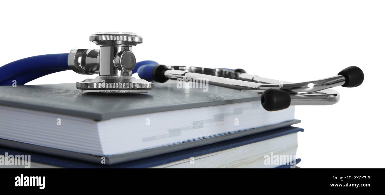 Stethoscope on stack of books against white background Stock Photo - Alamy