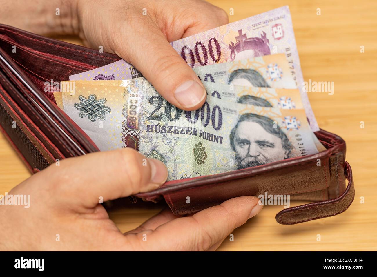 Hand takes out money from the wallet, Hungary forints, concept, rising prices, value of Hungarian currency Stock Photo