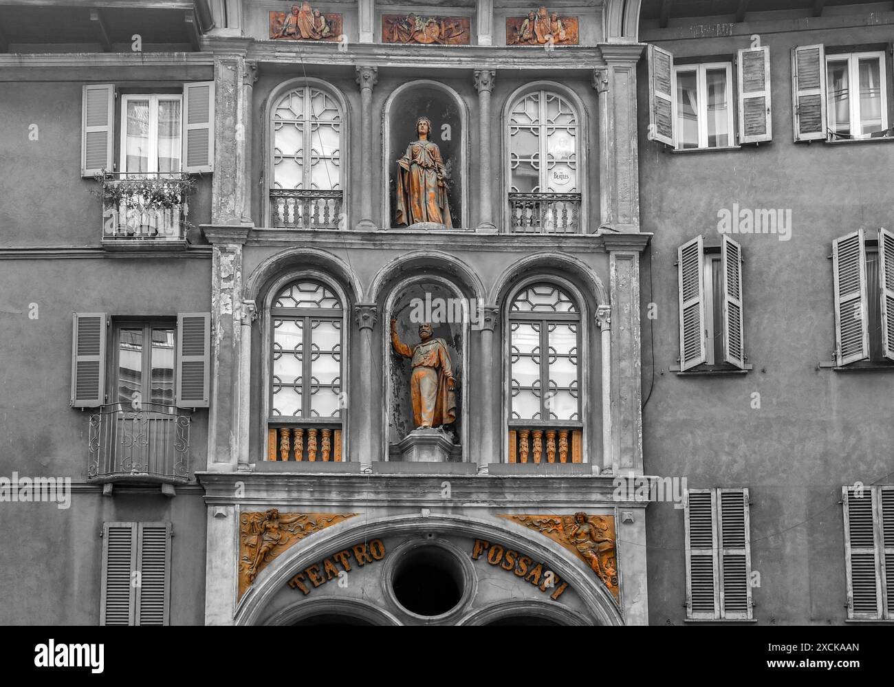 Black and white with selective color. The Teatro Fossati (1859) with terracotta decorations, including a statue of Giuseppe Garibaldi, Milan, Italy Stock Photo