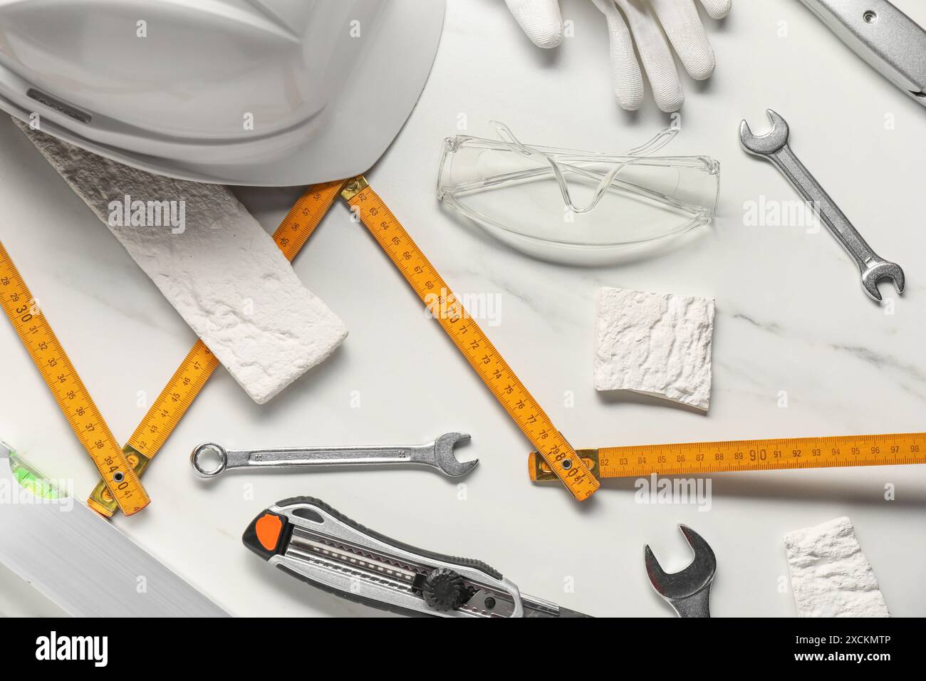 Flat lay composition with different construction tools on white marble background Stock Photo