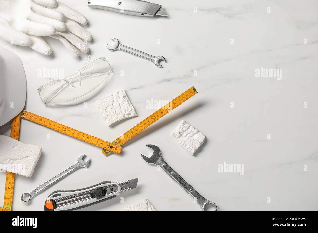 Flat lay composition with different construction tools on white marble ...