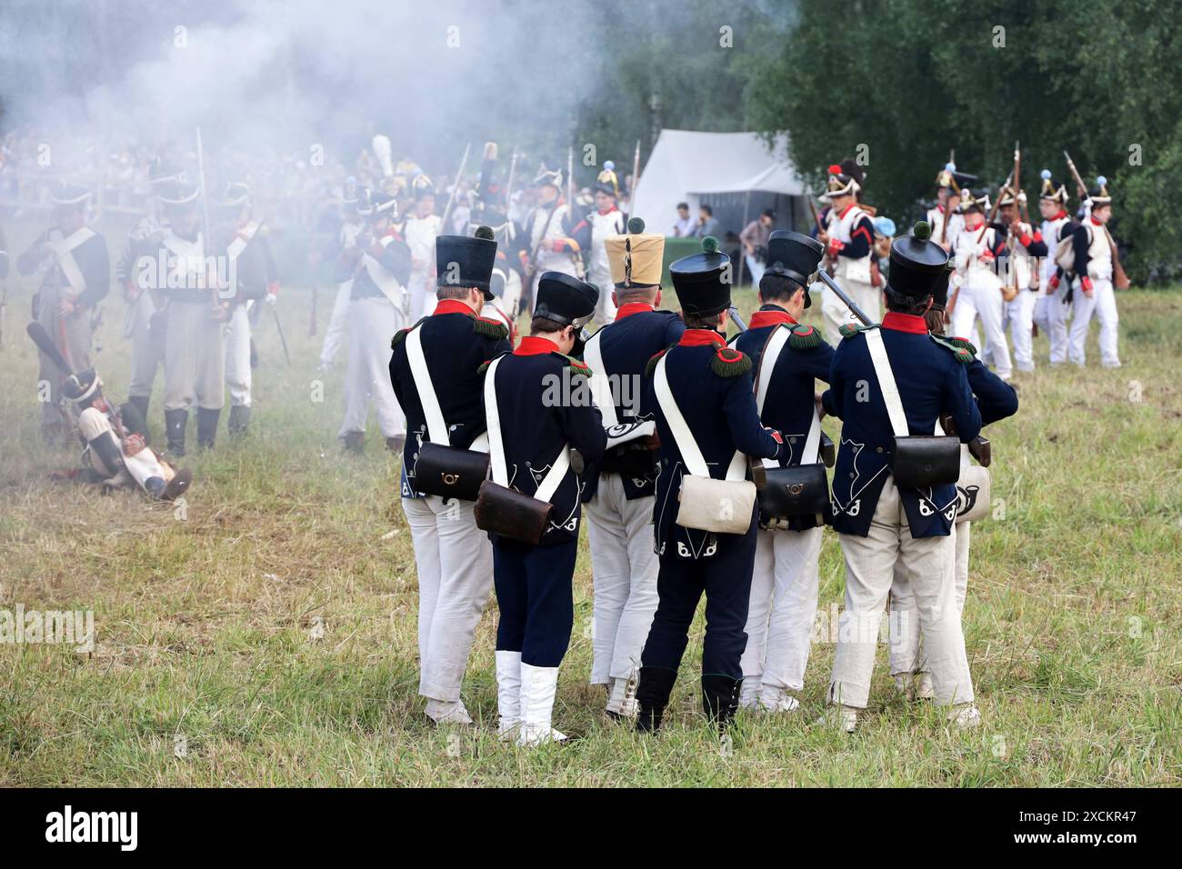 Battle of the French army of Napoleon (in foreground) and Russian army during historical reconstruction of 1814 on festival Times and Epochs Stock Photo