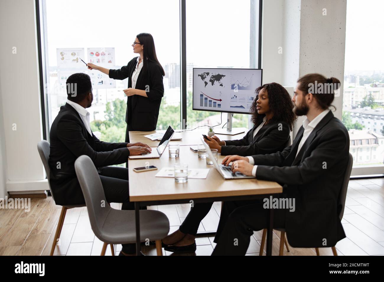 Presenting Woman presenting documents colleagues hi-res stock photography and ...