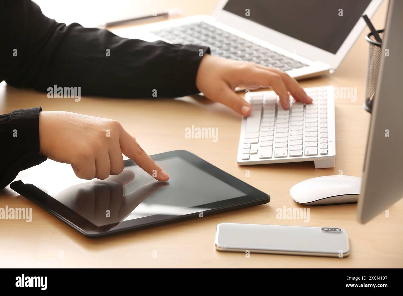 Female programmer working with tablet computer in office, closeup Stock Photo