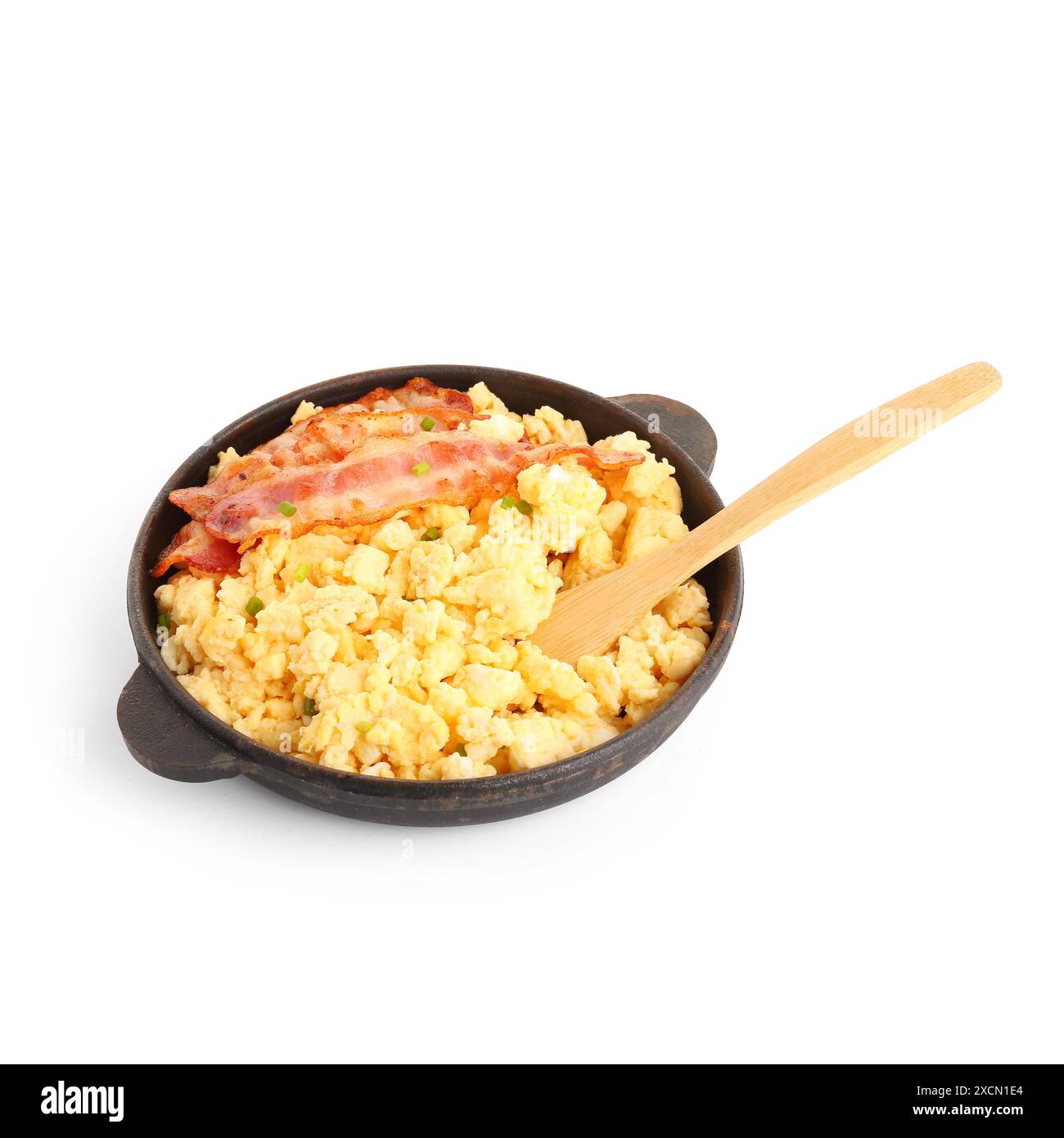 Frying pan of tasty scrambled eggs with bacon on white background Stock ...