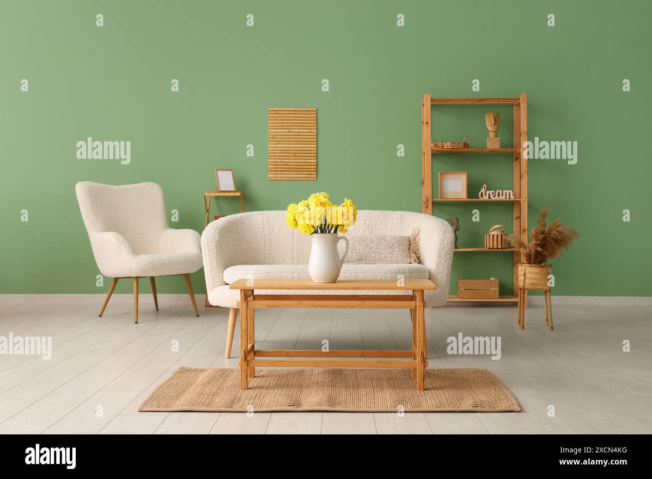 Interior of living room with sofa, coffee table and daffodil flowers in ...