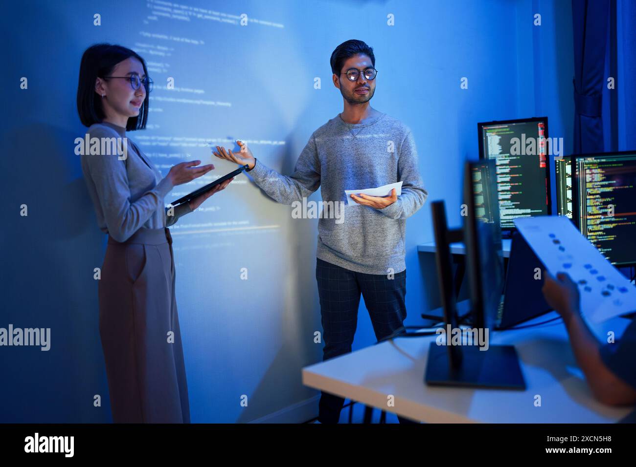 Mentor pointing code on monitor hi-res stock photography and images - Alamy