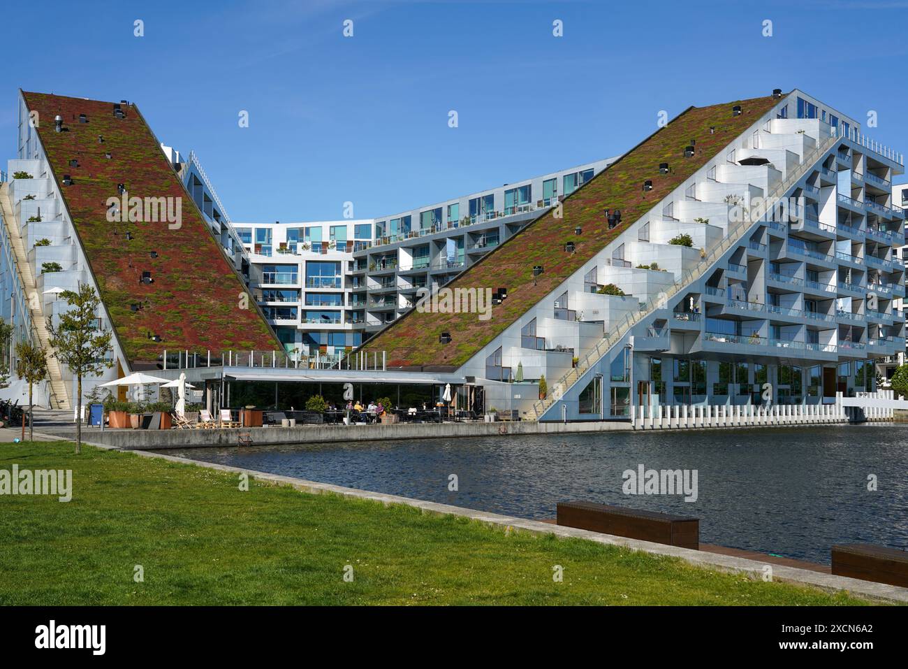 8house residential building with a big green roof in Ørestad, Copenhagen, Denmark designed by architect Bjarke Ingels Group Stock Photo