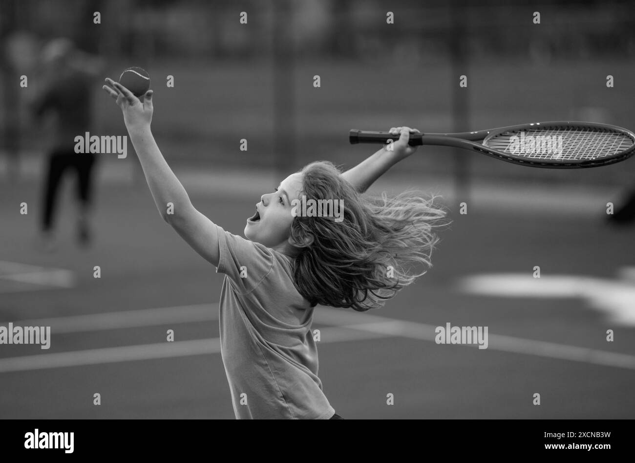 Child boy playing tennis on court. Little kid hit tennis ball with ...