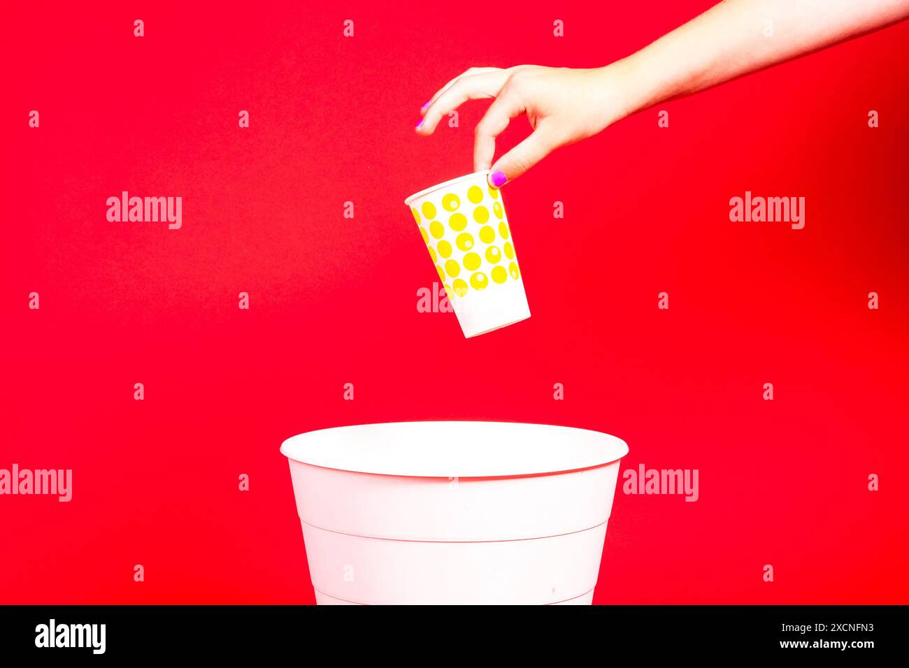 Closeup hand throwing empty paper disposable coffee cup in recycling ...
