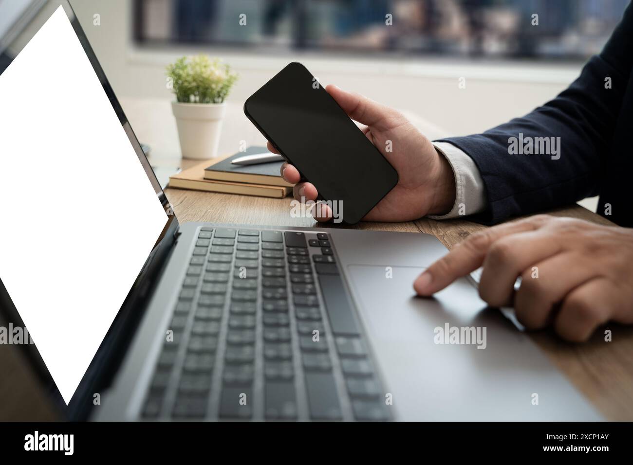 man Using laptop mock up computer looking at mockup empty screen white computer screen in home Stock Photo