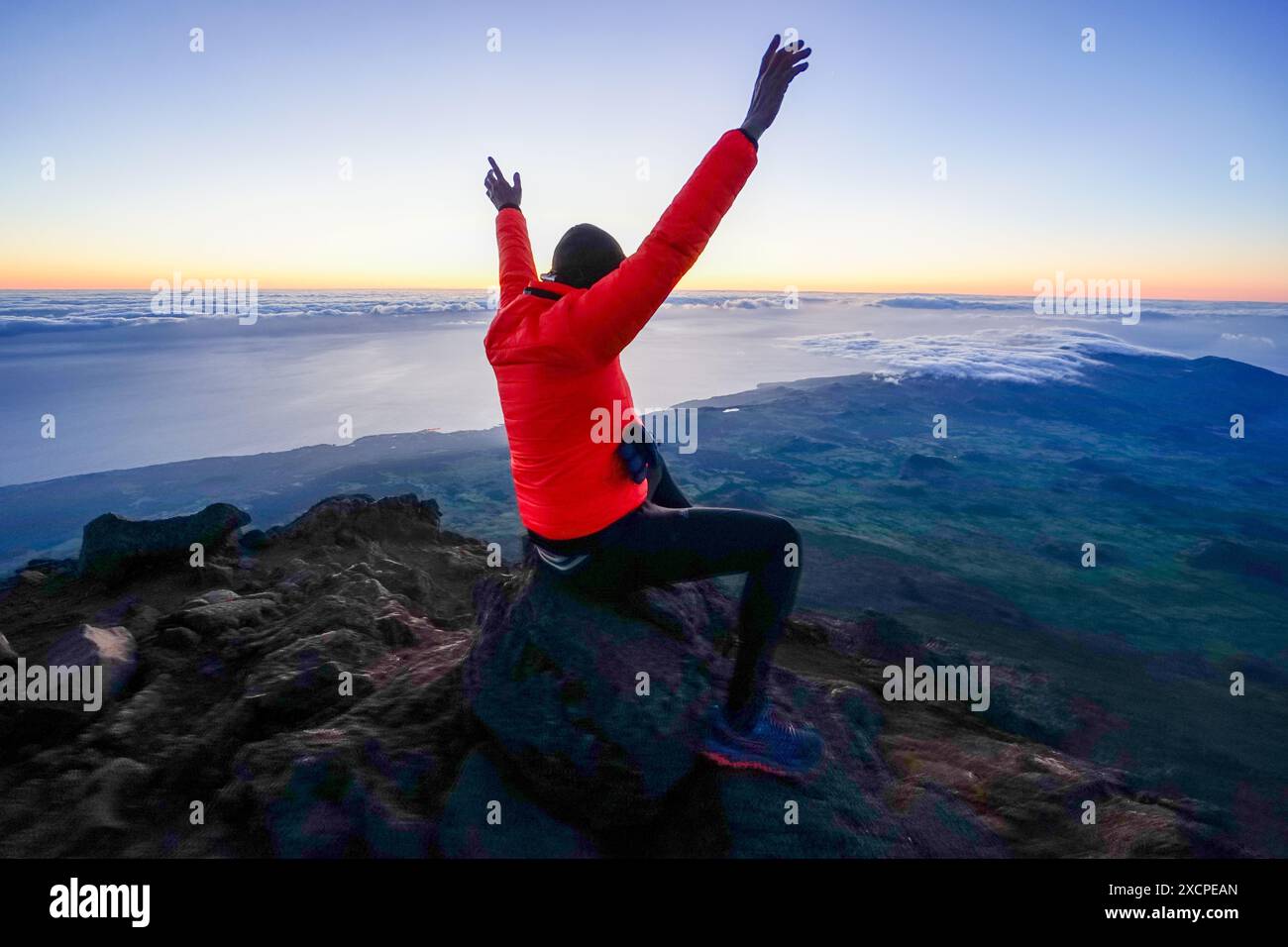 unidentified individual in a sign of victory upon reaching the top of the mountain, Pico-Açores-Portugal Stock Photo