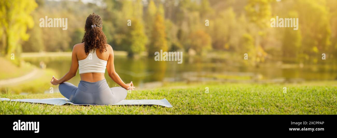 Back view young sportswoman meditating hi-res stock photography and ...